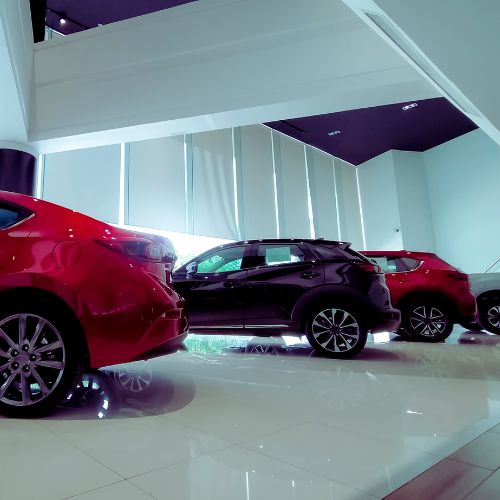 Professional janitorial team cleaning an auto dealership showroom